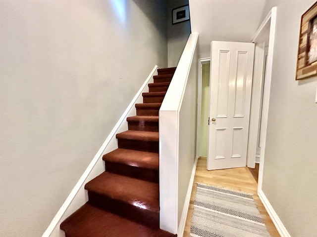 staircase featuring wood-type flooring