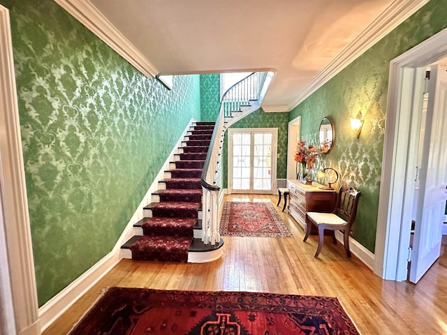 interior space featuring wood-type flooring and crown molding