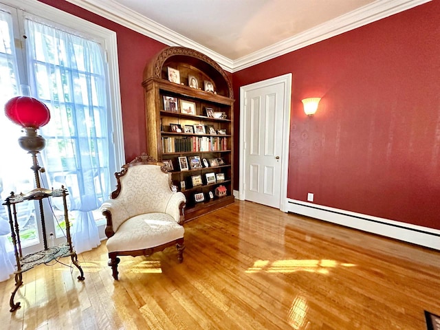 living area featuring crown molding, hardwood / wood-style floors, and a baseboard radiator