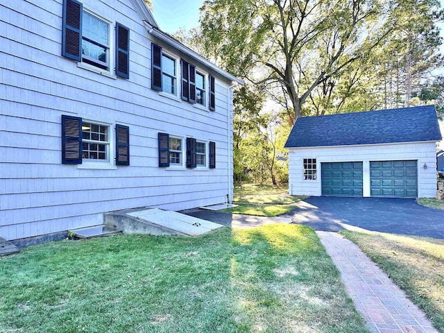 view of home's exterior featuring an outbuilding, a yard, and a garage