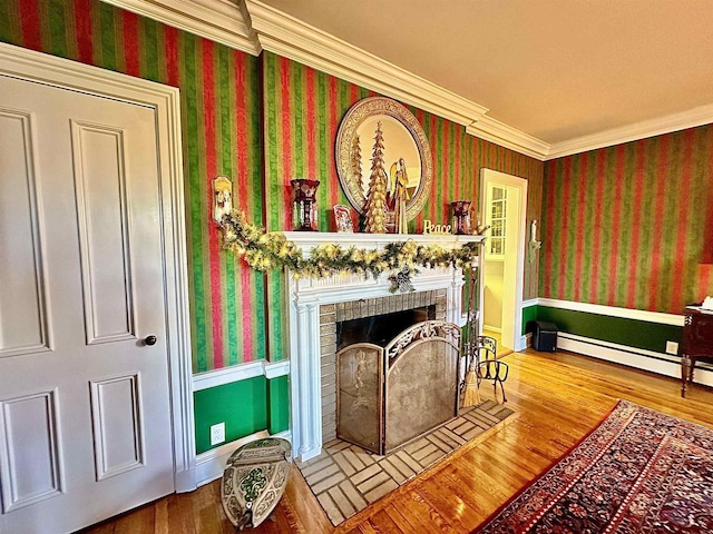 living room featuring hardwood / wood-style floors, crown molding, and a brick fireplace