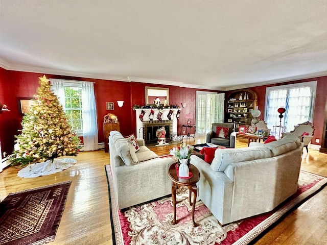 living room featuring light wood-type flooring and crown molding