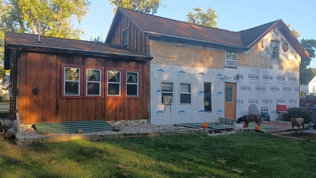 rear view of property with a yard