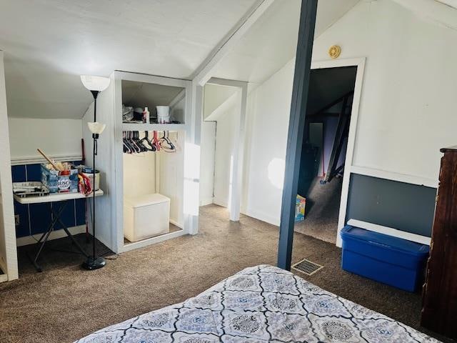 bedroom featuring vaulted ceiling and carpet