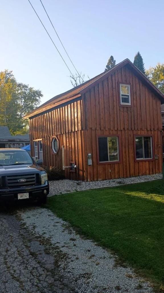 view of property exterior with a yard