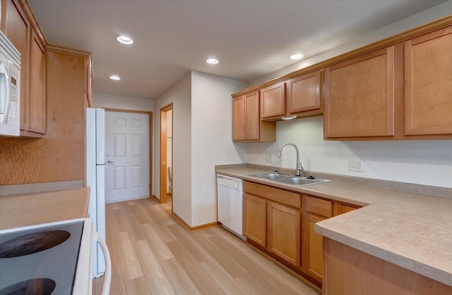 kitchen featuring white appliances, sink, and light wood-type flooring