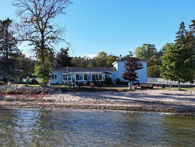 back of house featuring a water view