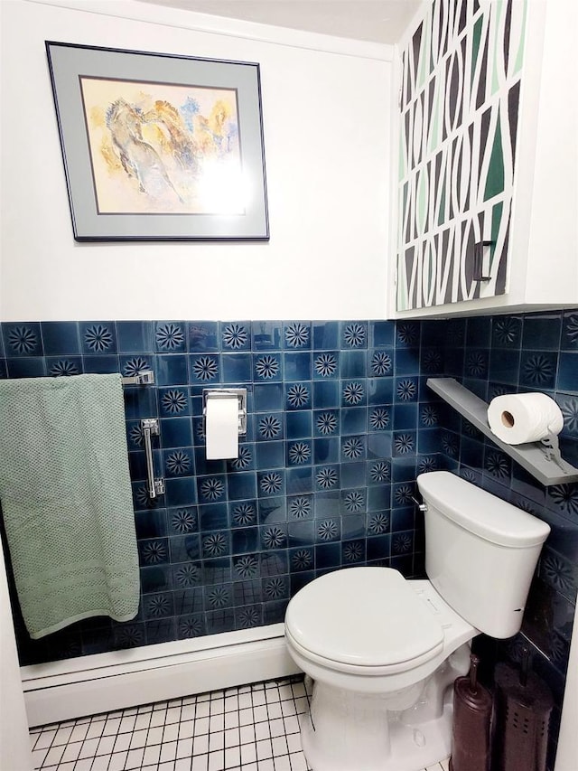 bathroom with tile walls, toilet, and tile patterned flooring