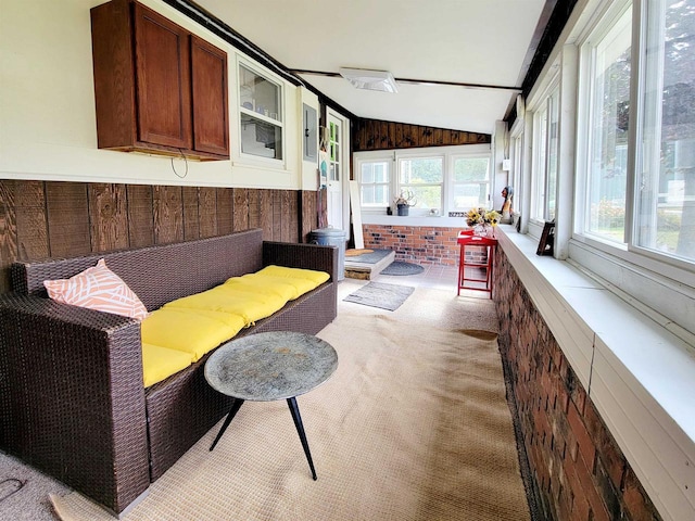 sunroom with plenty of natural light and vaulted ceiling