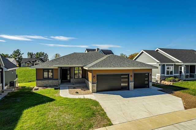 view of front of house with a front lawn, cooling unit, and a garage