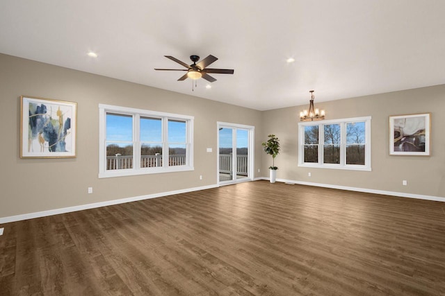 W4946 Battlestone Station Rd Unit 23, La Crosse, WI 54601 - unfurnished living room with ceiling fan with notable chandelier, dark wood-style flooring, baseboards, and recessed lighting