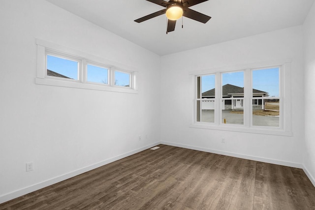 W4946 Battlestone Station Rd Unit 23, La Crosse, WI 54601 - unfurnished room with a healthy amount of sunlight, a ceiling fan, baseboards, and dark wood-style floors