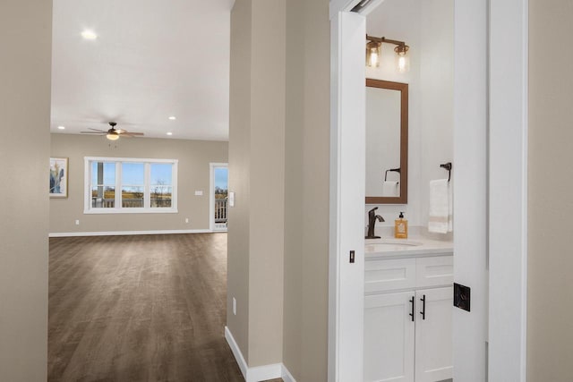 W4946 Battlestone Station Rd Unit 23, La Crosse, WI 54601 - corridor with a sink, baseboards, recessed lighting, and dark wood-style floors