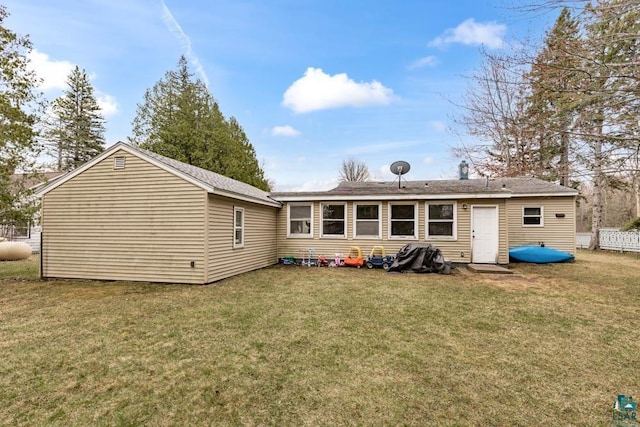 rear view of house with a yard