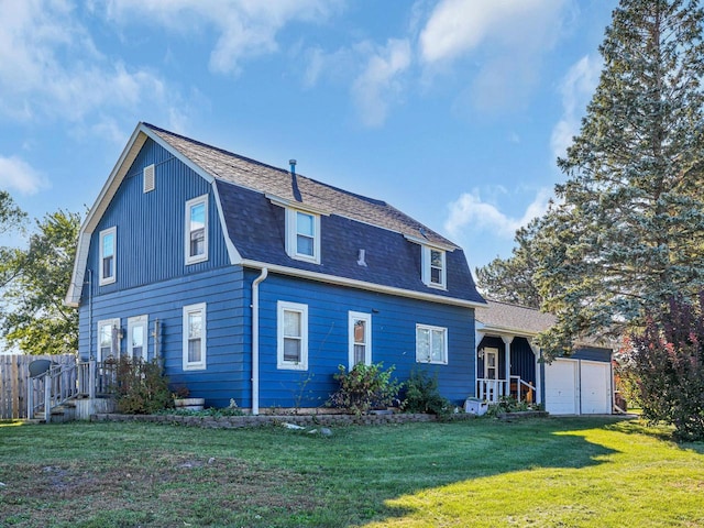 back of house with a lawn and a garage