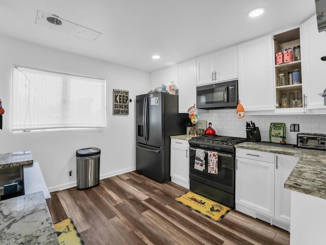 kitchen featuring black appliances, decorative backsplash, dark wood-type flooring, white cabinetry, and stone counters