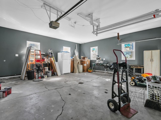 garage with a garage door opener and white refrigerator