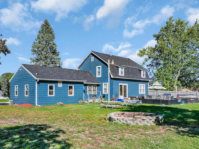 rear view of house featuring a yard