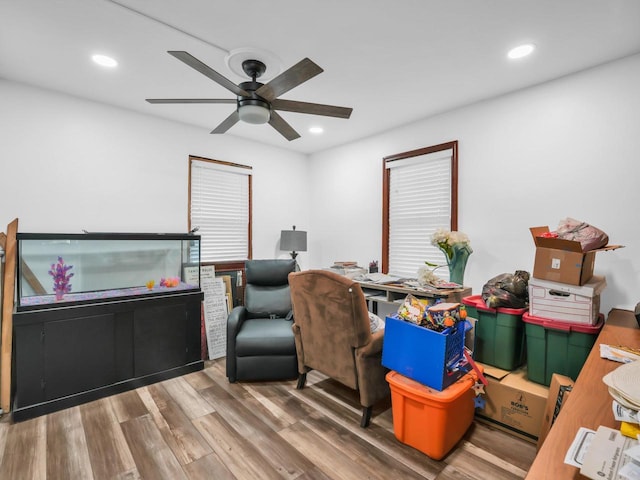 office area with wood-type flooring and ceiling fan