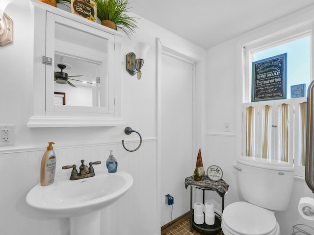 bathroom with ceiling fan, sink, and toilet