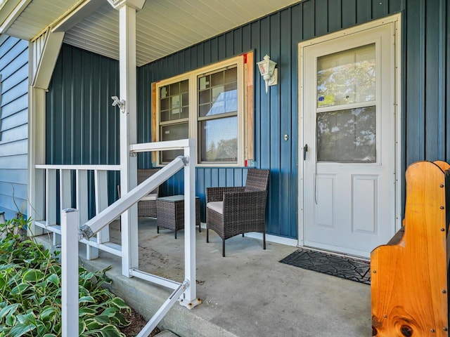 view of exterior entry featuring covered porch