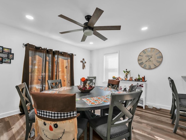 dining space featuring dark wood-type flooring and ceiling fan