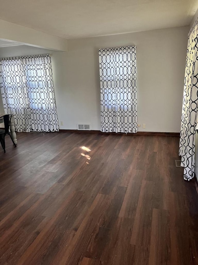 spare room featuring dark hardwood / wood-style flooring