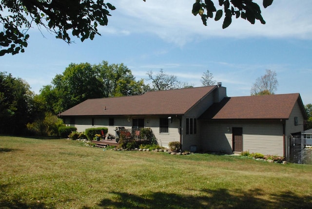 back of property featuring a lawn