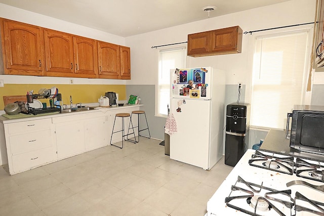 kitchen featuring white appliances and sink