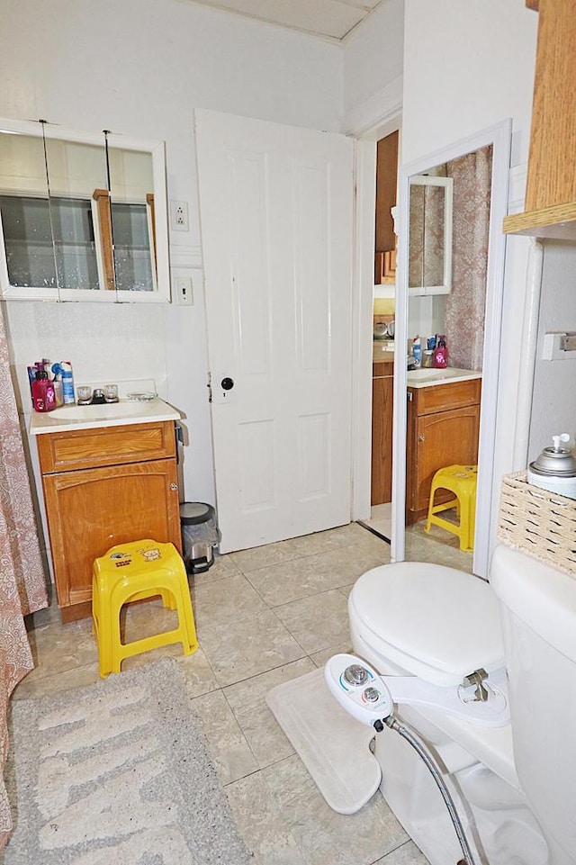 bathroom with vanity, tile patterned flooring, and toilet