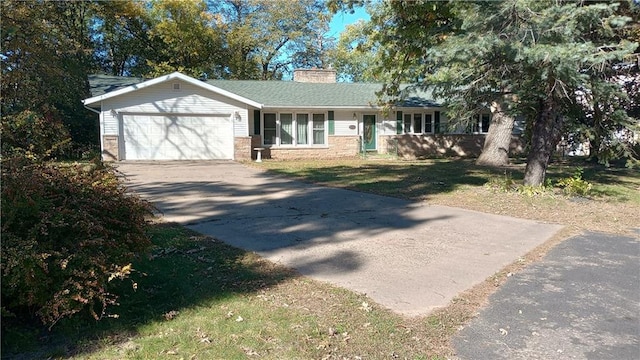 single story home featuring a garage and a front lawn