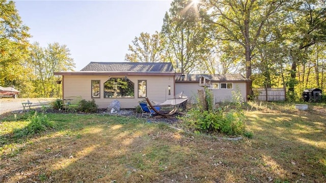 rear view of property with a yard