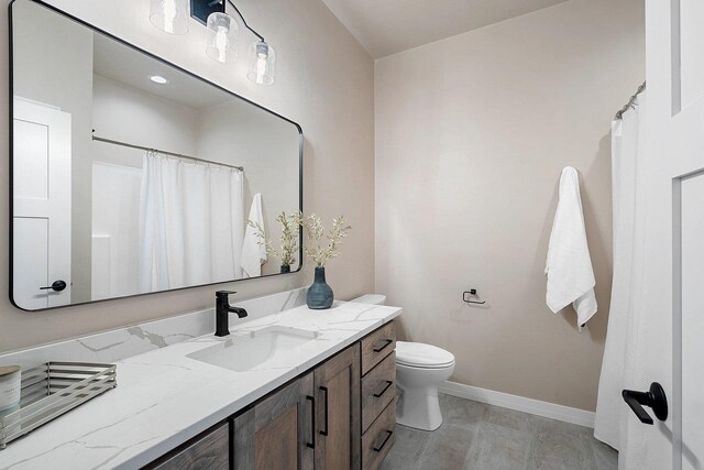 bathroom featuring toilet, vanity, and wood-type flooring