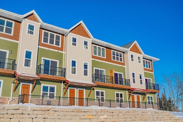 exterior space featuring board and batten siding and fence