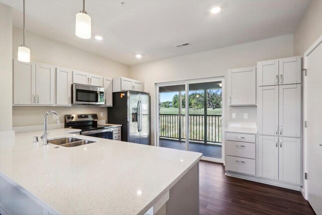 kitchen featuring dark hardwood / wood-style flooring, sink, stainless steel appliances, kitchen peninsula, and white cabinetry