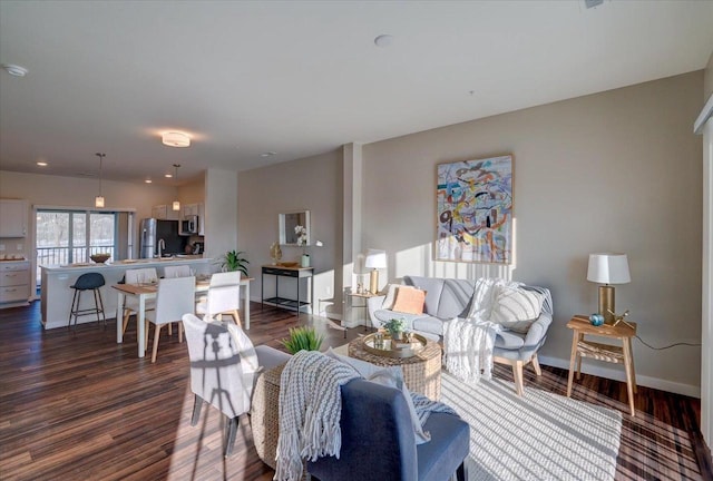 living room with dark wood-style flooring and baseboards