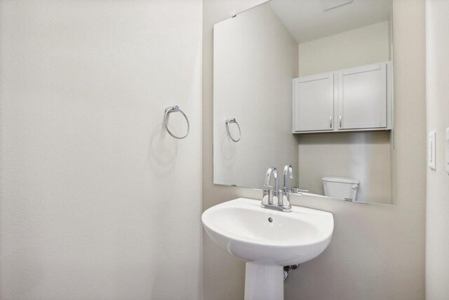 bathroom featuring sink and toilet