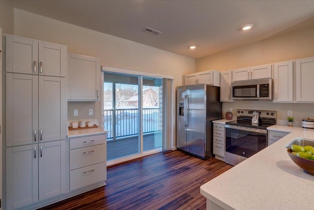 kitchen with visible vents, white cabinets, appliances with stainless steel finishes, recessed lighting, and dark wood-type flooring