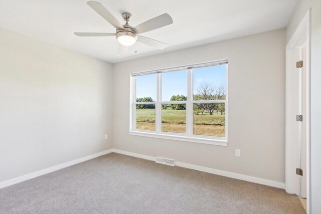 carpeted empty room with ceiling fan