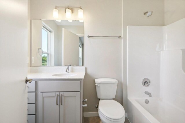 full bathroom with shower / bathing tub combination, vanity, and toilet