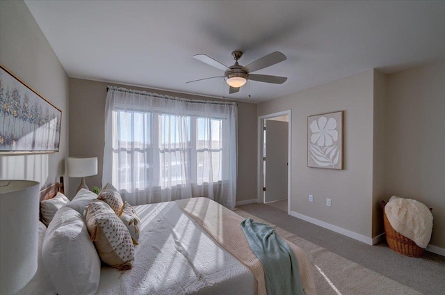 bedroom featuring ceiling fan, baseboards, and carpet floors