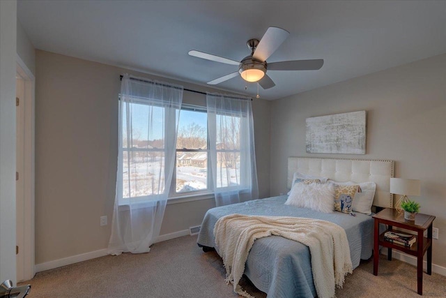 bedroom with baseboards, a ceiling fan, and carpet floors