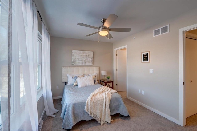 bedroom featuring ceiling fan, visible vents, baseboards, and carpet floors