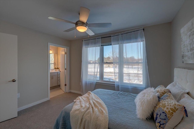 bedroom featuring baseboards, a ceiling fan, connected bathroom, and light colored carpet