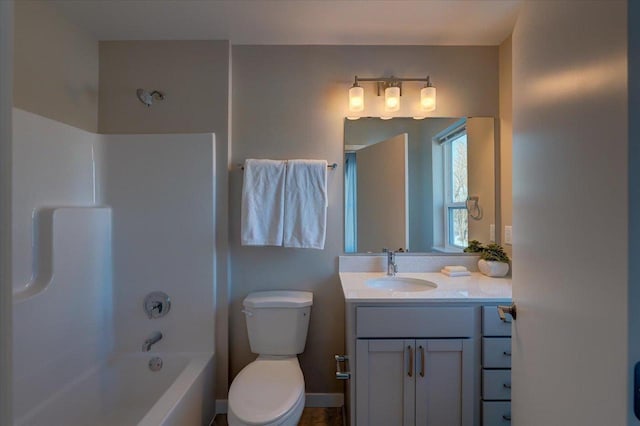 full bathroom featuring bathing tub / shower combination, vanity, baseboards, and toilet