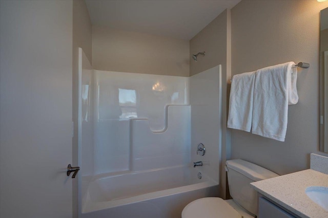 full bathroom featuring  shower combination, vanity, and toilet
