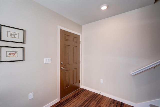 entrance foyer featuring dark wood-style flooring and baseboards