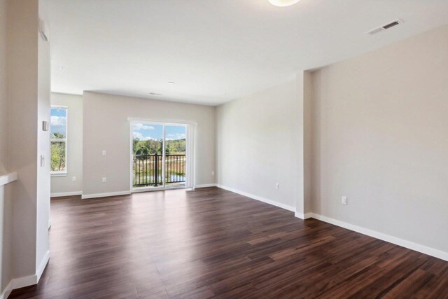 spare room with dark wood-type flooring