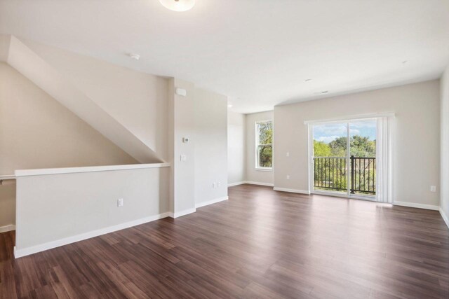 unfurnished living room featuring dark wood-type flooring