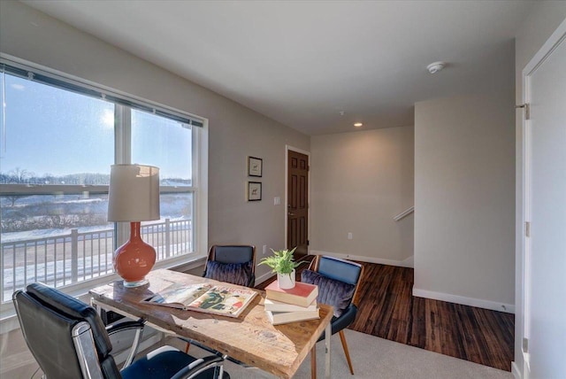 dining area with baseboards and wood finished floors